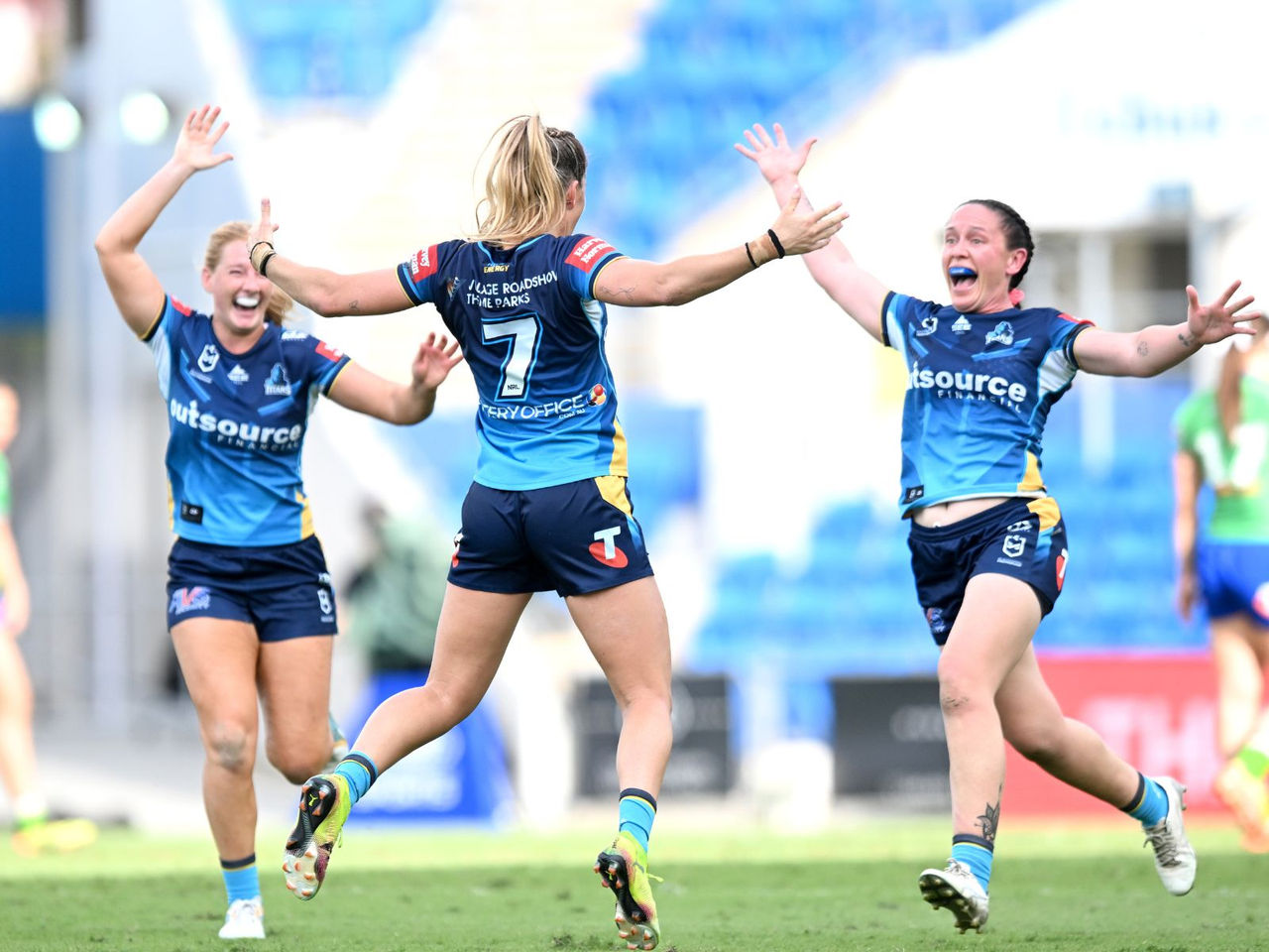 NRLW Gold Coast Titans three players celebrating on the field