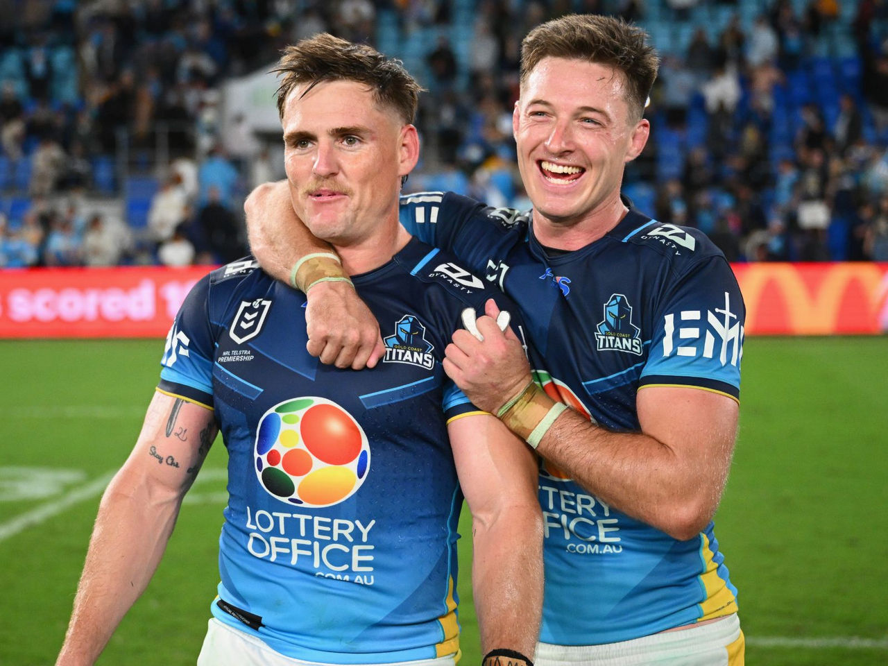 NRL Gold Coast Titans two players smiling on field