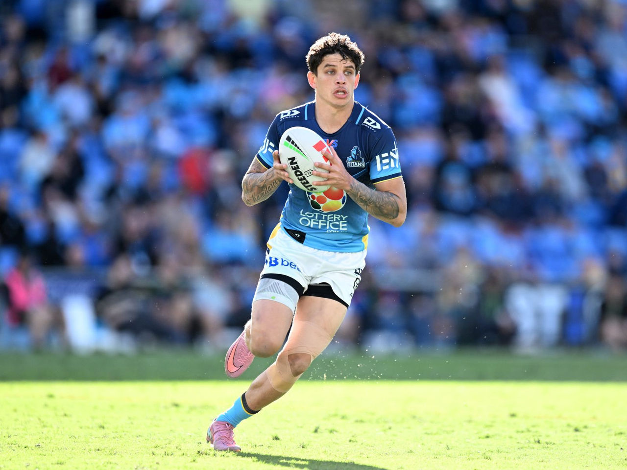 NRL Gold Coast Titans players running on the field